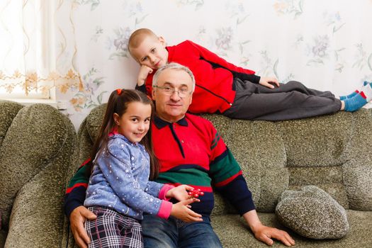 Grandparents spending time with grandchildren on couch