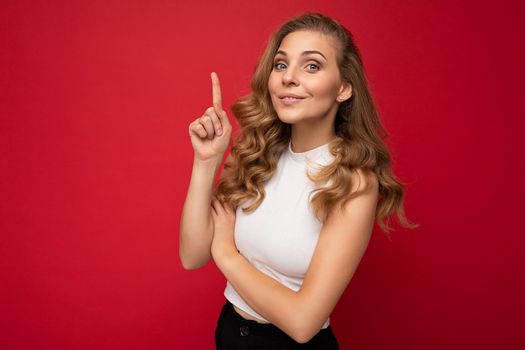 Photo of young positive happy smiling beautiful woman with sincere emotions wearing stylish clothes isolated over background with copy space and having an idea.