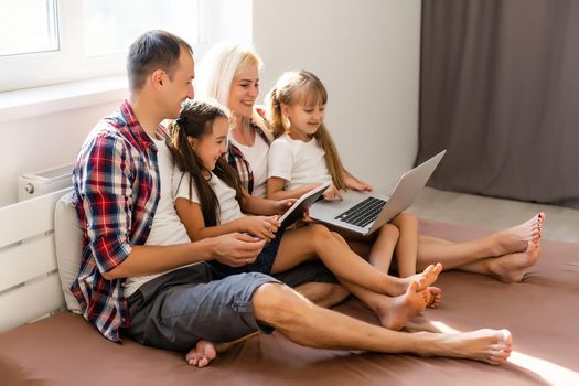 Animated family buying online lying down on bed at home