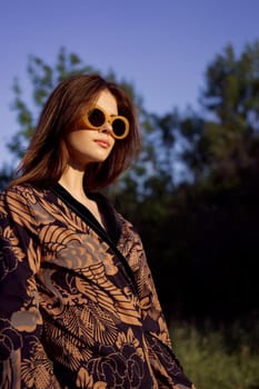 pretty woman in fashionable clothes sunglasses nature posing. High quality photo