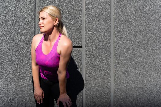 Sport woman doing stretching exercise during outdoor cross training workout
