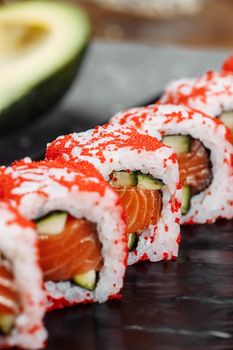 California sushi style rolls, with raw vegetables, food border background.