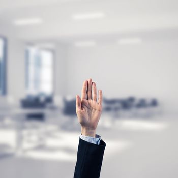 Close of businesswoman hand touching screen with palm and office at background