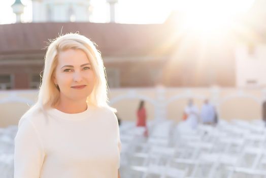 an empty concert hall, woman near empty chairs at concert