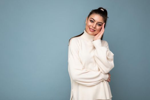 Photo of cute nice charming gorgeous pretty youngster smiling toothily isolated over blue color background with empty space.