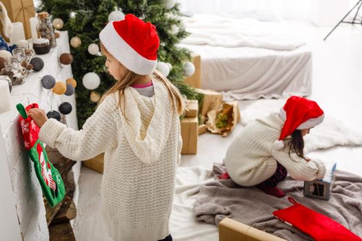 christmas, x-mas, winter, happiness concept - two adorable girls playing.