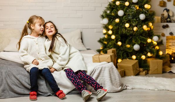 Two little girls in Christmas background.