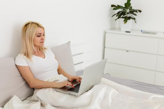 Woman working behind laptop