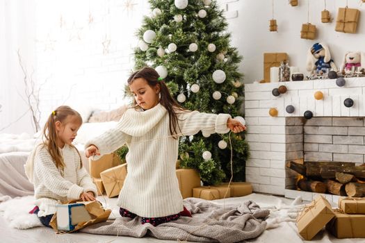 Two little girls in Christmas background.