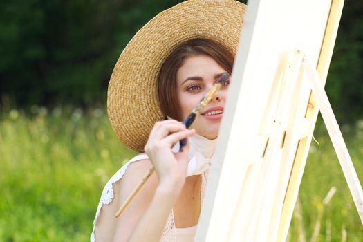 Woman in white dress artist paints on nature palette creative. High quality photo