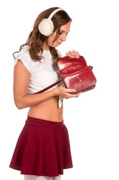 Beautiful woman looking through her pocket book purse, isolated