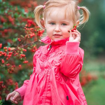 little cute girl on a warm autumn day on the walk