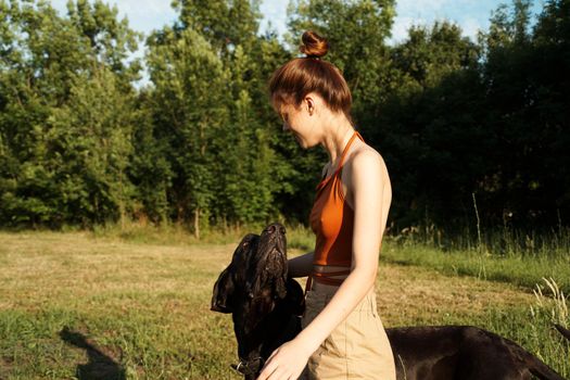 Cheerful Woman and a dog in the nature games Friendship. High quality photo