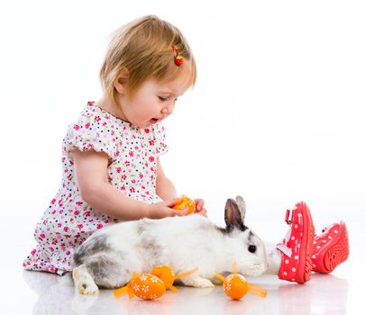 Easter photo. Cute little girl in a summer dress with a rabbit isolated on white background