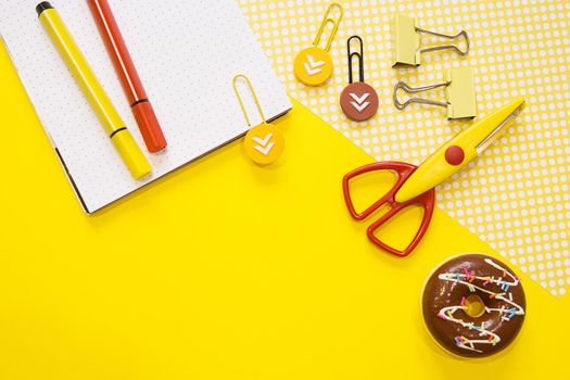 School supplies. Yellow and red colors. Flat lay composition. Yellow background. Space for text. Back to school.