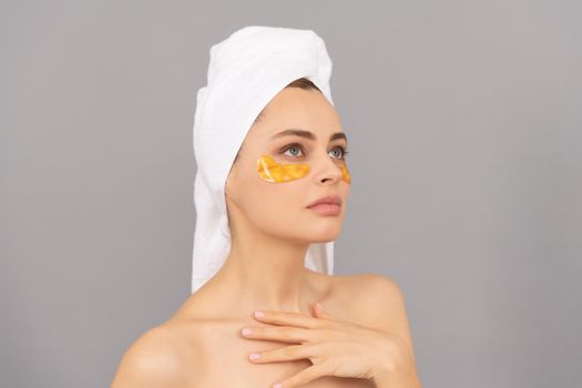 young woman with terry towel use facial golden eye patch for skin, skin.