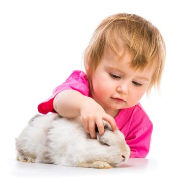 baby girl with her small white rabbit isolated on white background