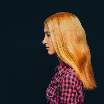 Fashionable attractive blonde young woman wearing in plaid shirt indoor