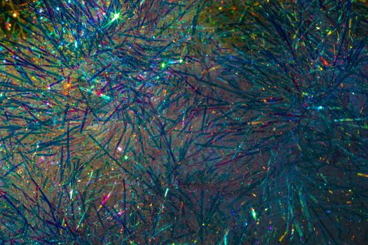 Multicolored glowing tinsel, sparkling christmas decoration, christmas background.