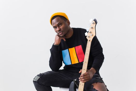 Studio shot of young handsome African man wearing hoodie against white background.
