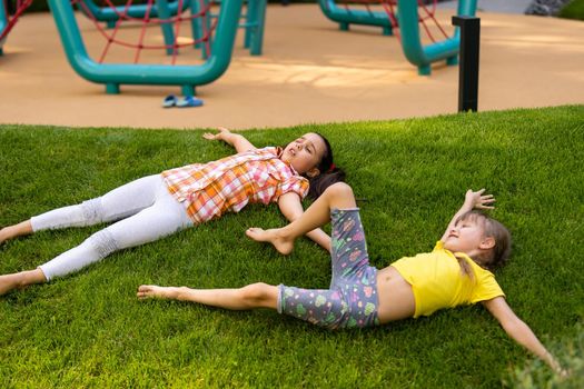 Portrait of two little girls sisters fighting on home backyard. Friends girls having fun. Lifestyle candid family moment of siblings quarreling playing together.