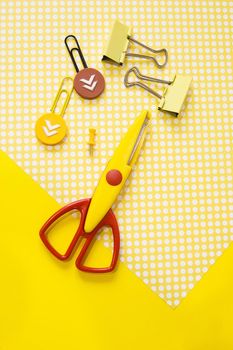 School supplies. Yellow and red colors. Flat lay composition. Yellow background. Space for text. Back to school.