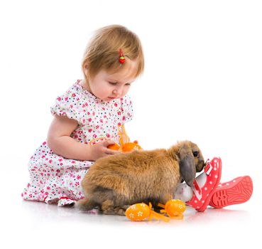 Easter photo. Cute little girl in a summer dress with a rabbit on white background