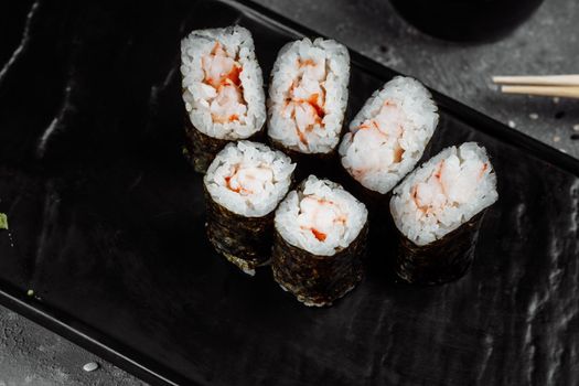 Simple maki with shrimp. Sushi on a gray background.