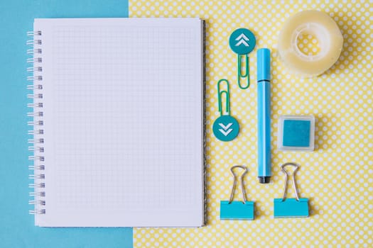 School supplies. Yellow and blue colors. Empty notebook. Flat lay composition. Space for text. Back to school.