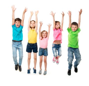 beautiful children in colorful clothes jumping together with hands up isolated on white background