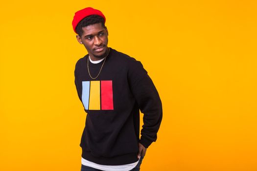 Studio shot of young handsome African man wearing hoodie against white background.