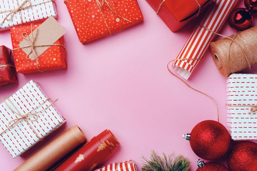 Christmas festive decorations with copy space on pink background, top view