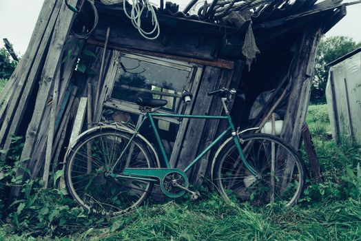 Bicycle on background of old barn outdoor