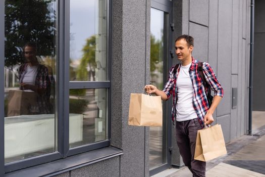 delivery man with paper containers for takeaway food.