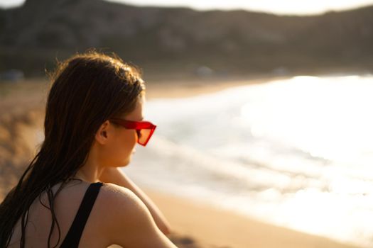 woman in a black swimsuit on the beach sea Summer vacation. High quality photo