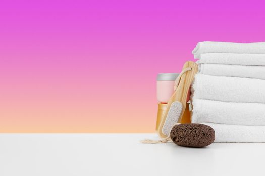 Spa still life with stacked towels and spa stone, front view