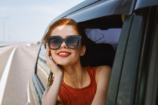 pretty woman in sunglasses rides in a travel car. High quality photo