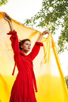 festively outdoors yellow cloth on the background of posing red dress. High quality photo