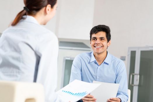 portrait of a young man at a business meeting. concept of team work