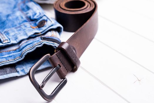 male jeans, belt and shoes on wooden background