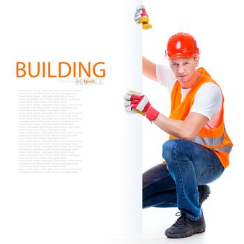 happy working man in a helmet with a white blank with space for text