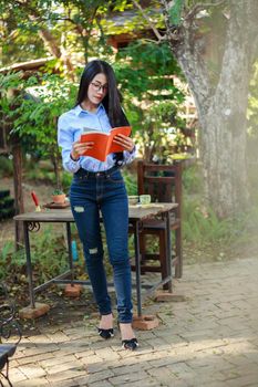 portrait woman reading a book in the garden