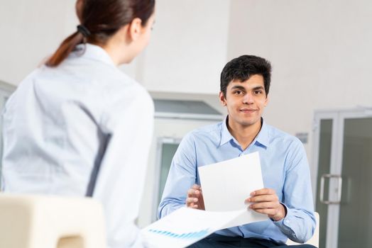 portrait of a young man at a business meeting. concept of team work