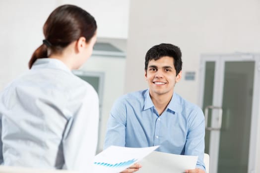 portrait of a young man at a business meeting. concept of team work