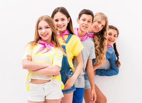 cute teenage children standing one by one on white background