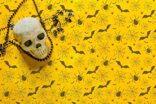 Scary skeleton decoration on the table for Halloween, copy space