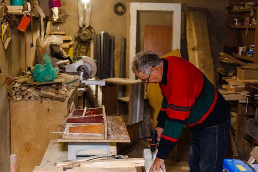 Image of mature carpenter in the workshop