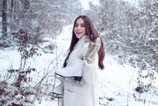 Winter woman. Laughing Girl Outdoors. Model wearing stylish sweater and gloves. Portrait of a young woman in snow trying to warm herself. Winter woman