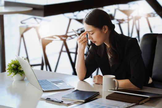 Company employees show boredom from unfinished work using computer notebook, documents and tablets at work