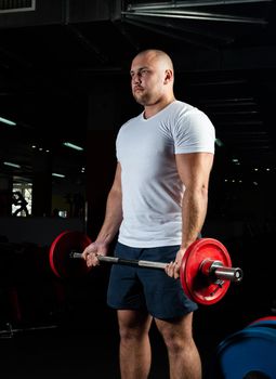 Man in the gym lifts the barbell. bodybuilding and healthy lifestyle